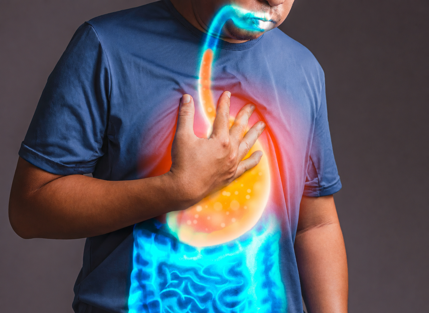 Veteran holding his chest with an illustration of acid reflux rising from the stomach into the esophagus